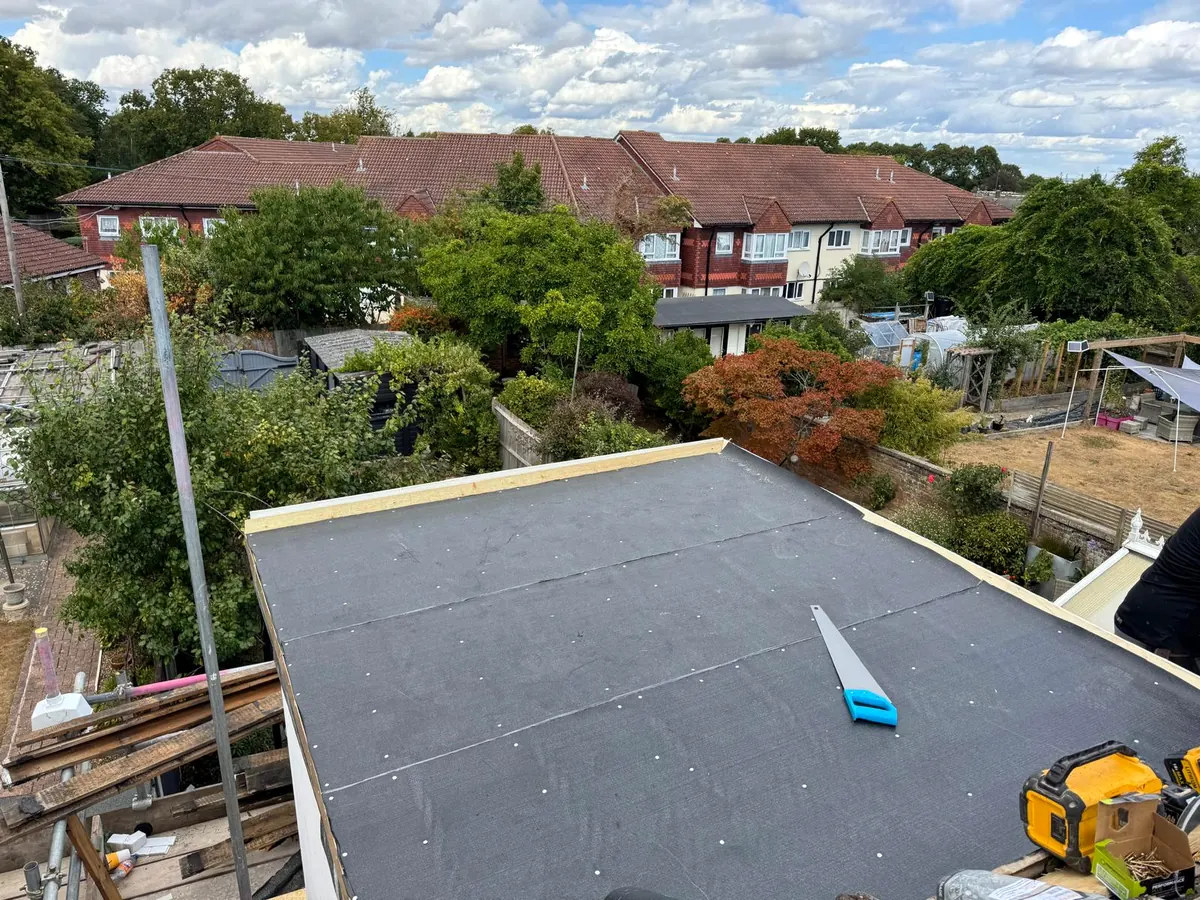 Membrane laid across the new deck, edges trimmed to the fascia